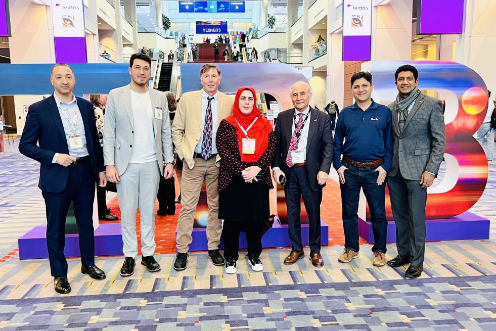 Iteris team standing in front of sign at TRB Annual Meeting